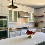 A clean kitchen with stainless steel appliances and white cabinets