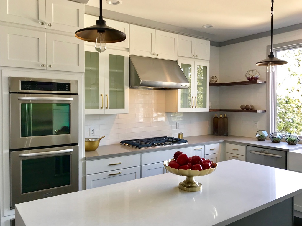 A clean kitchen with stainless steel appliances and white cabinets
