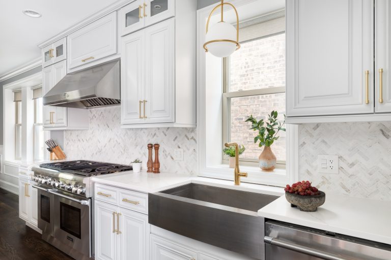 A beautiful kitchen with grey cabinets and stainless steel appliances.