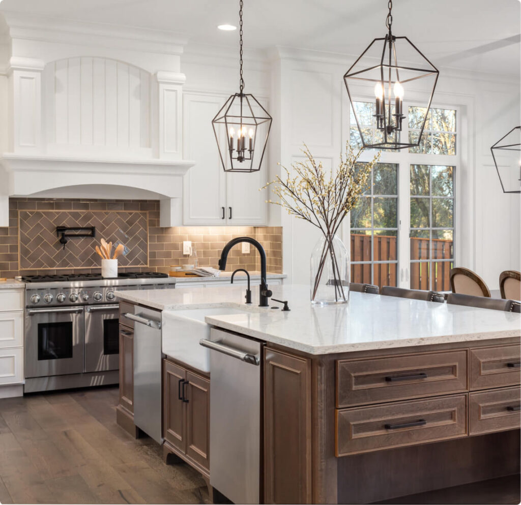 beautiful kitchen in new traditional style luxury home with quartz counters hardwood floors and stainless steel appliances